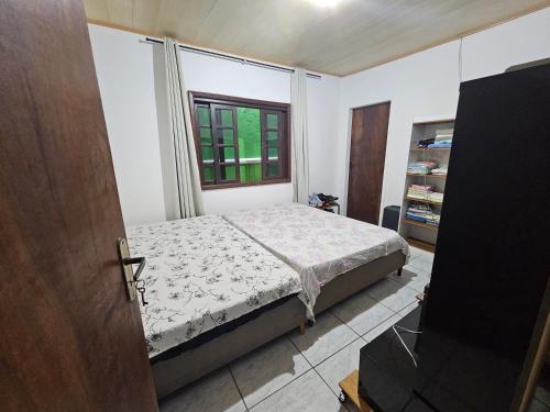 En eller flere senge i et værelse på Pousada Wisocki