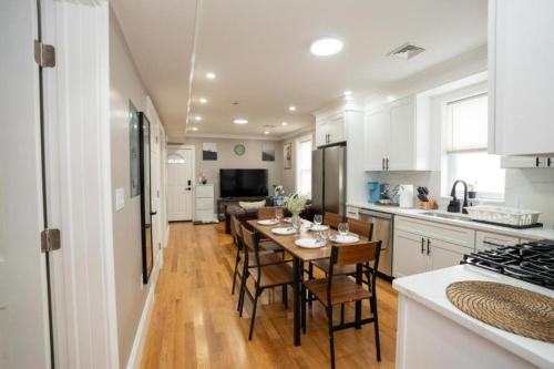 a kitchen with a table and chairs in a kitchen at 558-3 3BR Boston - Modern Nest near Franklin Park in Boston