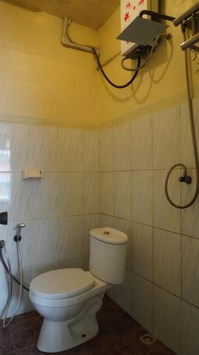 a bathroom with a toilet and a shower at BROMO B&B in Bromo