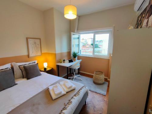 a bedroom with a large bed and a window at Lovely room in city centre in Leiria