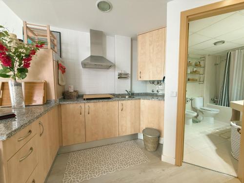 a kitchen with a sink and a toilet at Ático Dúplex con Jacuzzi en Vera Playa y parking cubierto enorme in Vera