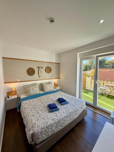 a bedroom with a bed and a large window at Albufeira Solmare Suites in Albufeira