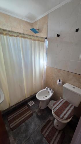 a bathroom with a toilet and a sink at Cabañas Ganesha in Federación