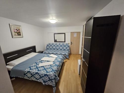 克拉约瓦Hotel Mina的小房间设有两张床和橱柜