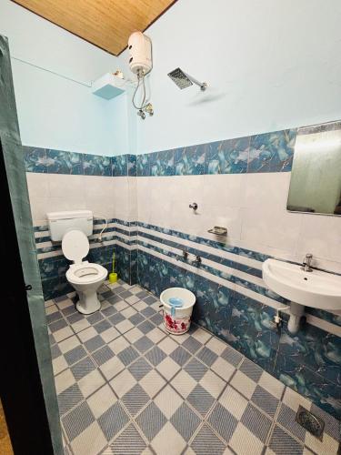 a bathroom with two toilets and a sink at Pheonix home stay in Vagamon