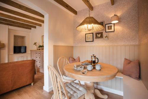 a kitchen and dining room with a wooden table at Briar Cottage Paxton, Berwick Upon Tweed in Berwick-Upon-Tweed