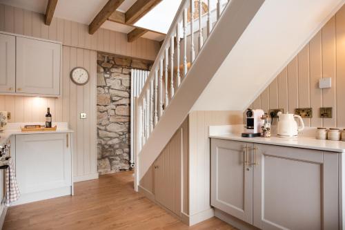 a kitchen with a staircase and a counter top at Briar Cottage Paxton, Berwick Upon Tweed in Berwick-Upon-Tweed