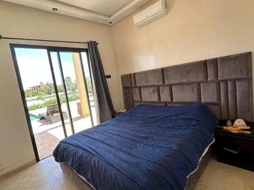 ein Schlafzimmer mit einem großen Bett mit großem Kopfteil in der Unterkunft Villa l'odyssée in Marrakesch