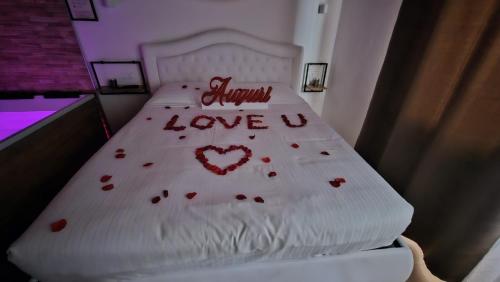 a bed with a white bed with hearts on it at Villa Joy Verona - Lovely Suite in Verona