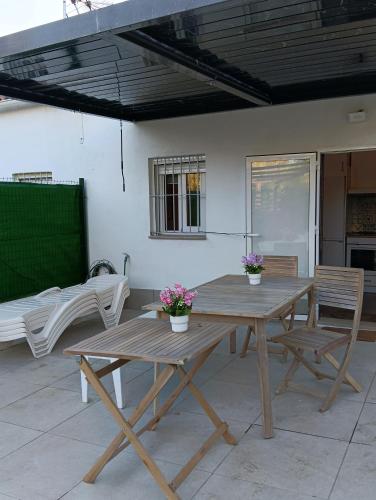 a wooden table and chairs on a patio at Finca Las Abuelas in Galaroza
