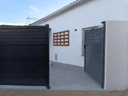 a pair of black doors on the side of a building at Finca Las Abuelas in Galaroza