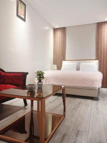 a bedroom with a bed and a coffee table at Riad Sevilla in Rabat
