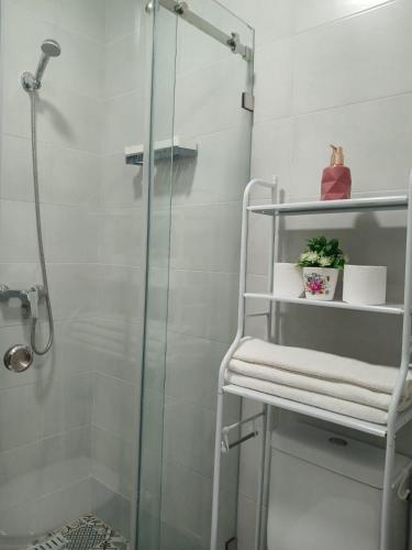 a shower with a glass door in a bathroom at Riad Sevilla in Rabat