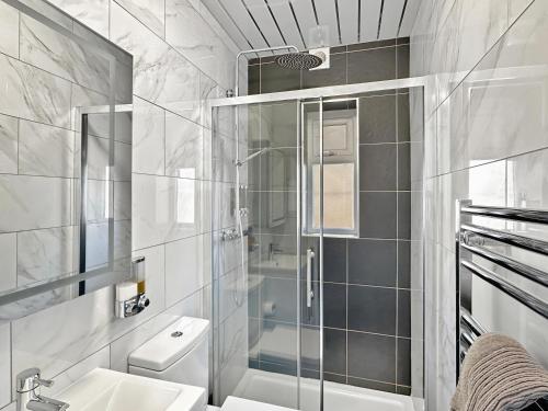 un bagno con doccia, WC e lavandino di Granada Apartments Holmfield Rd a Blackpool