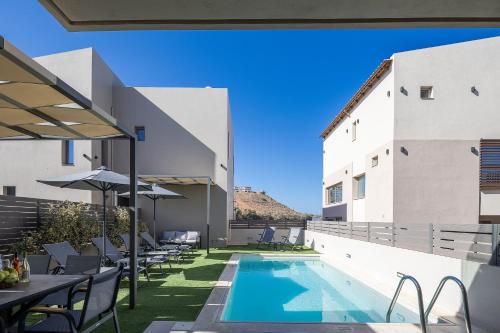 a view of the pool from the balcony of a building at New Modern Villas with Private Pools and Walking distance to Beach in Panormos Rethymno
