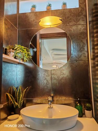 a bathroom with a sink and a mirror at Hotel George suite 2 in Limenas
