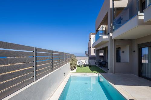 a swimming pool in the side of a building at New Modern Villas with Private Pools and Walking distance to Beach in Panormos Rethymno