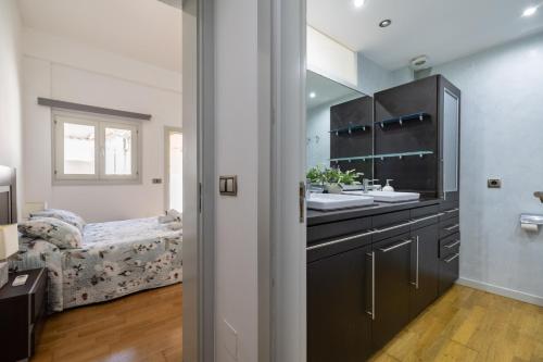 a bathroom with a sink and a bed in a room at Ca Se Predine by Rentallorca in Alcudia