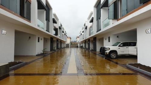 a flooded hallway of a building with a car parked in it at Ocube Shortlet in Mama