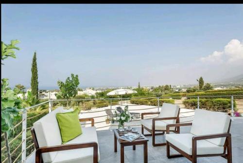 a group of chairs on a patio with a view at Amazing Sea View -3 Bed Ground Floor Garden Apartment in Kérynia