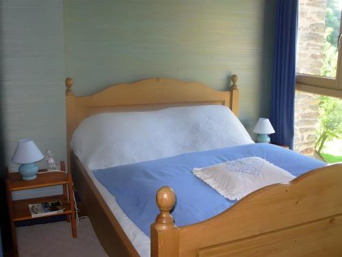 En eller flere senge i et værelse på Chambres - Ferme De Créac'h-Gourlès