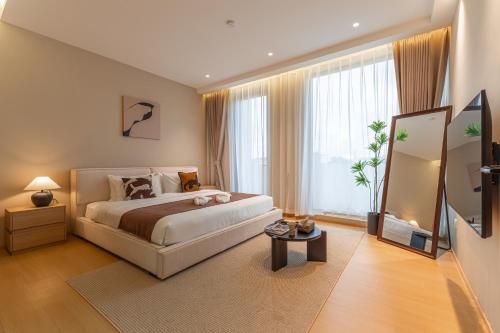 a bedroom with a bed and a large window at hiii Aura Pool Villa Hotel Pattaya Central in Pattaya Central