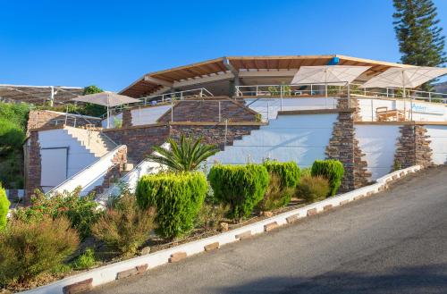 a house with a lot of plants in front of it at Lindian Jewel Hotel and Villas in Líndos