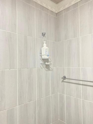 a bathroom with a shower with a soap dispenser on the wall at Blue Horizon Bed and Breakfast in Maseru