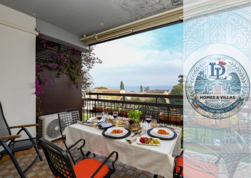 a table with plates of food on a balcony at CIAO LAGO Family Apartment DesenzanoLoft Official Partner Homes & Villas by Marriott Bonvoy in Desenzano del Garda