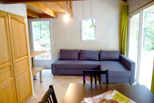 a living room with a couch and a table at Gîte du Jonquas in Velleron