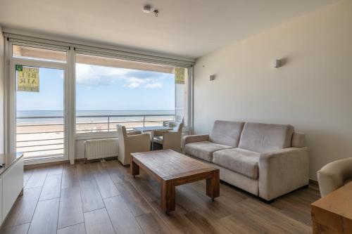 a living room with a couch and a table at BEL AIR HOLIDAY - Luxury 2-bedroom apartment with sea view & jacuzzi T48 in Ostend