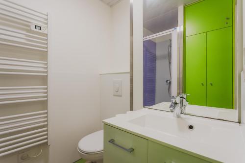 a bathroom with a sink and a green cabinet at L HELIOS Centre ville 1 chambre in Cauterets