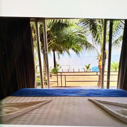 a bedroom with a view of the beach at kohrong sweet beach bungalows in Koh Rong Island