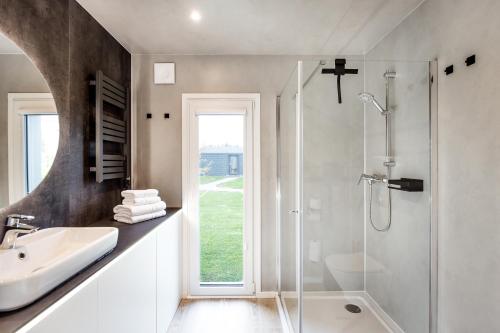 a white bathroom with a sink and a shower at Hundweiler Hofheimat in Markdorf