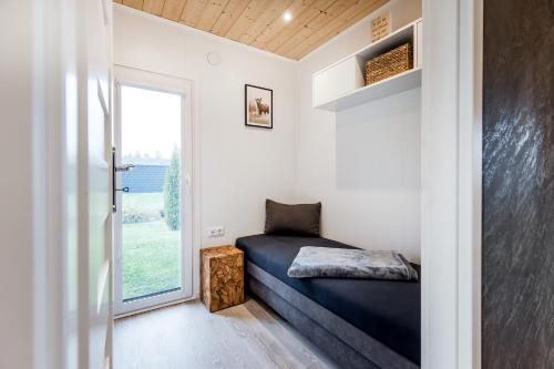 a small bedroom with a bed and a window at Hundweiler Hofheimat in Markdorf