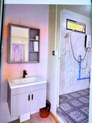 a bathroom with a sink and a shower at kohrong sweet beach bungalows in Koh Rong Island