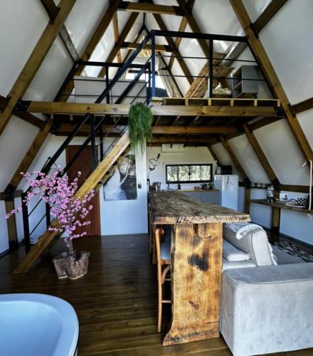 a room with a loft with wooden beams at Cabana Pehuen in Santa Maria do Erval