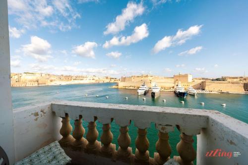 a view from a balcony of boats in the water at Stunning Holiday Home with Gorgeous Harbour Views in Senglea