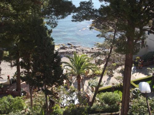 a view of the ocean through the trees at ToviMar Apartments in Taormina