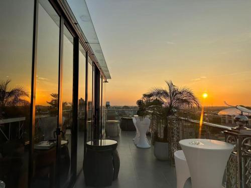 a balcony of a building with a sunset in the background at X-Digital HOTEL in Bắc Ninh