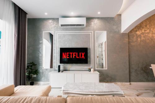 a living room with a netflix sign on the wall at Stunning 4BR Villa with Heated Jacuzzi in St Paul's Bay in St. Paul's Bay