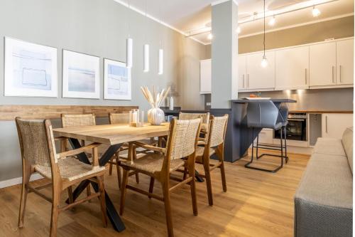 a kitchen and dining room with a wooden table and chairs at InselLoft Wohnung 1 in Borkum