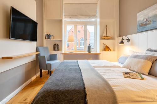 En eller flere senge i et værelse på Logierhaus K15 Appartement 7
