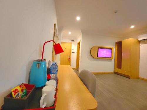a hospital room with a table and a tv at Ivy Hotel Aromire in Hausa
