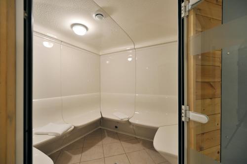 a small bathroom with a shower and a toilet at Les Hauts de Valmeinier in Valmeinier