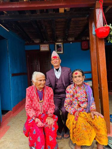 a group of three older people posing for a picture at Thir bahadur karki's Home 