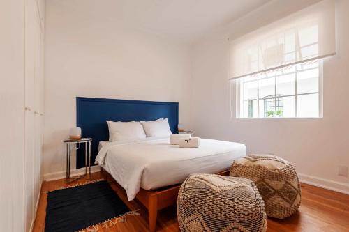 a bedroom with a bed with a laptop on it at Breezy 2BR in Polanco in Mexico City