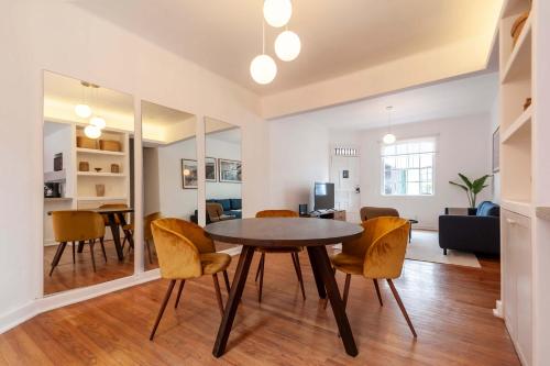 a dining room and living room with a table and chairs at Breezy 2BR in Polanco in Mexico City