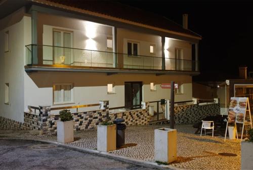 a building with a balcony on the side of it at Hostel Rosa in São Pedro de Moel