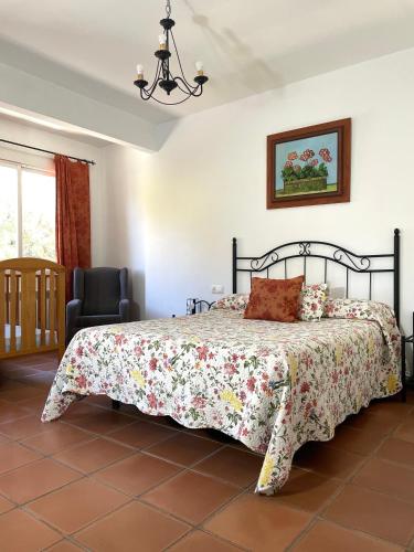 a bedroom with a bed and a chair at Hotel San Julian in Burunchel